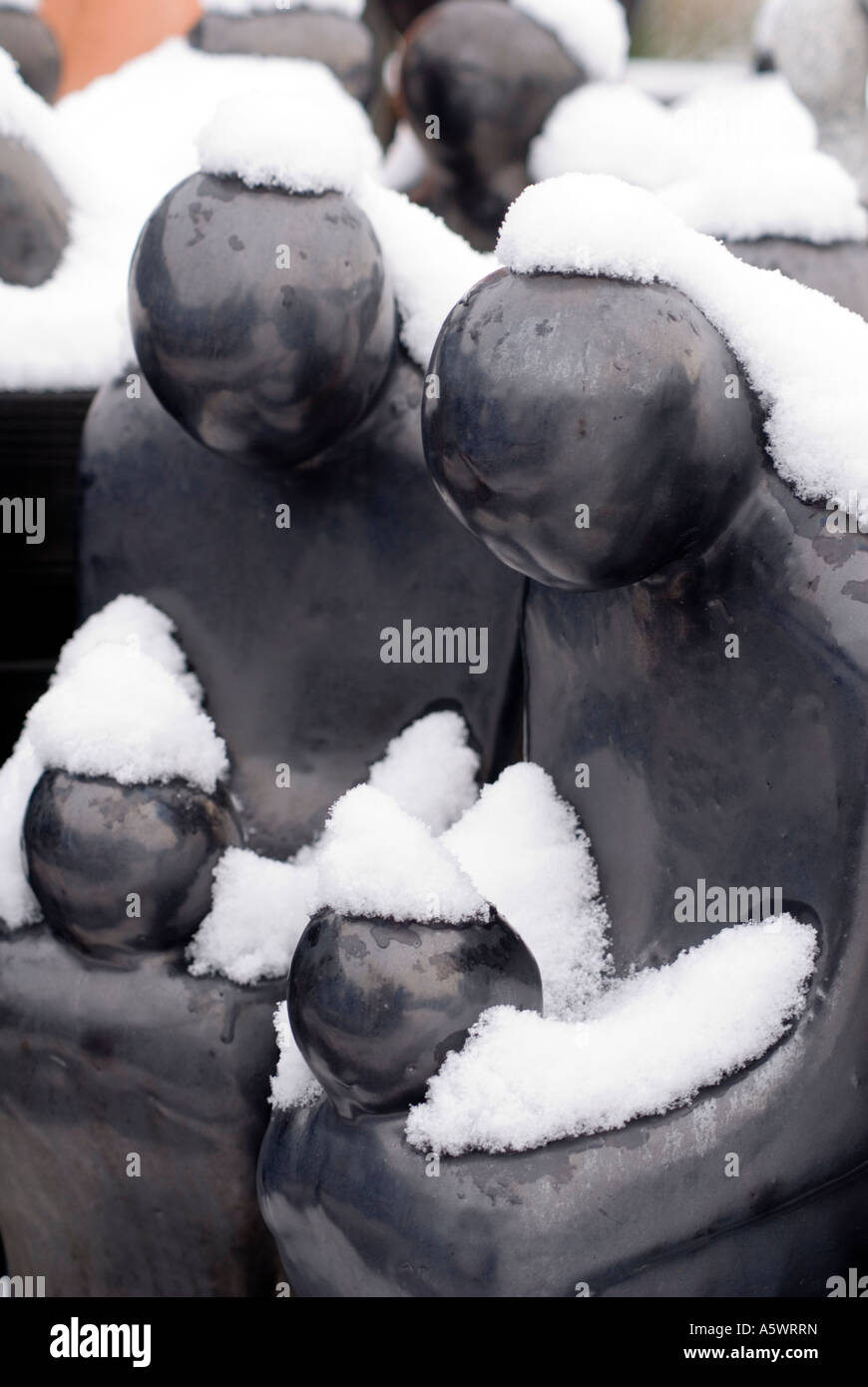 Garden ornaments covered by snow black earthenware figures Stock Photo