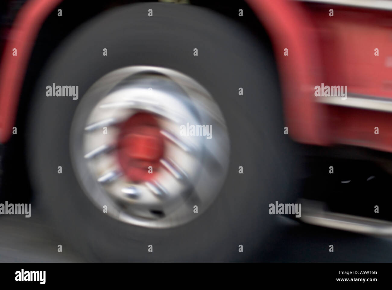 Red lorry wheels spinning Stock Photo