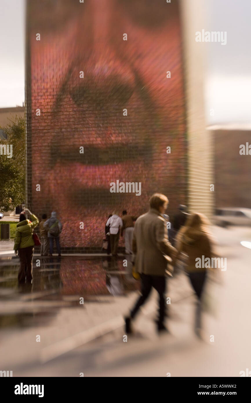 Crown Fountain by Jaume Plensa and couple walking Millennium Park Chicago Illinios USA Blurred effect. Stock Photo