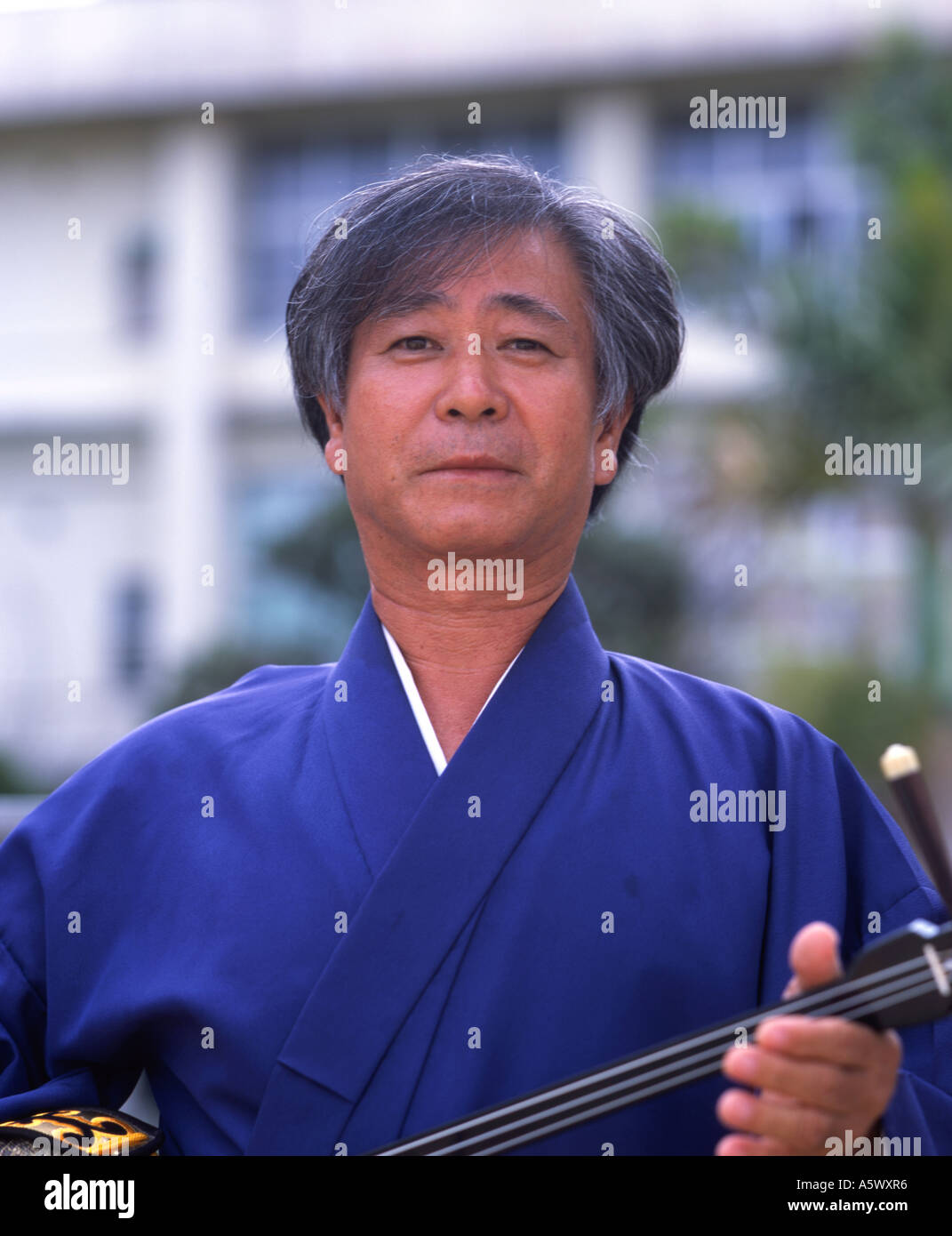 Okinawan man with sanshin the traditional three-stringed instrument of ...