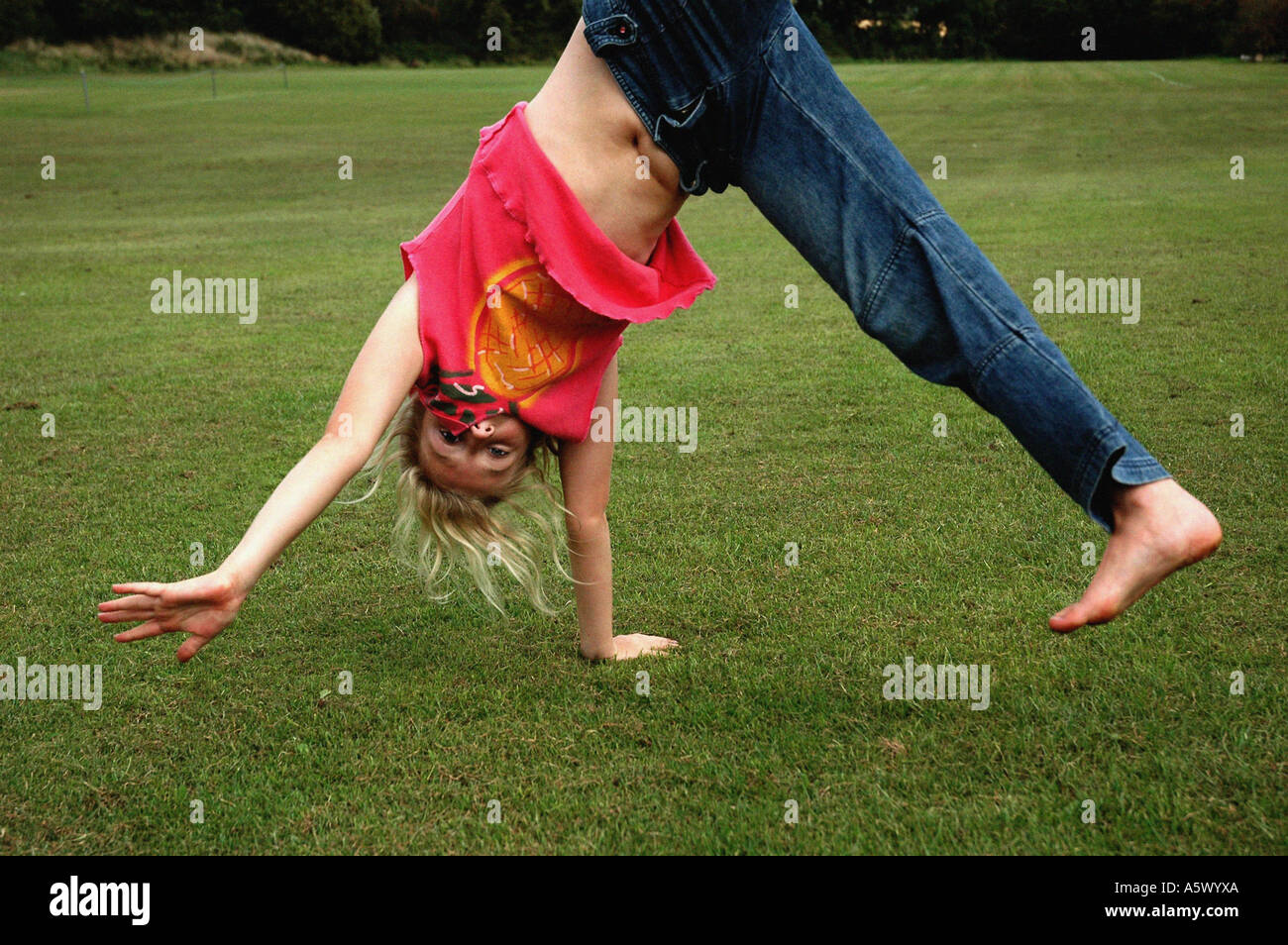 girl doing a cartwheel at the park Stock Photo