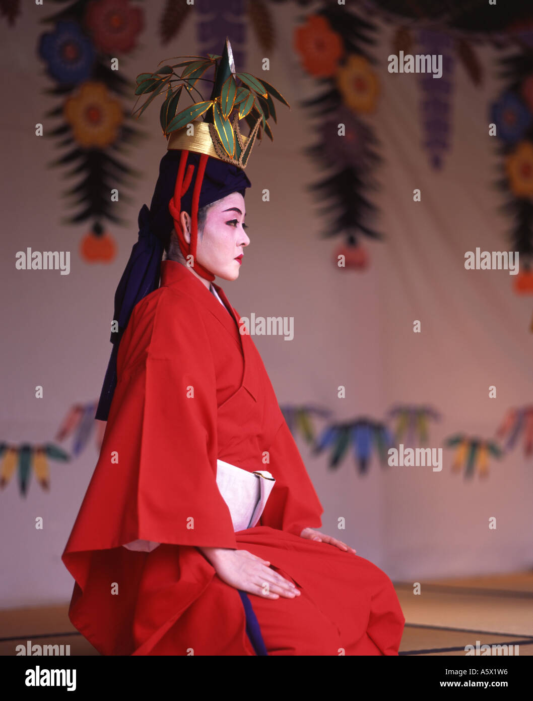 Shuri Castle, Okinawa, Japan a UNESCO world heritage site. Woman performing tradtional Okinawan dance in full costume Stock Photo