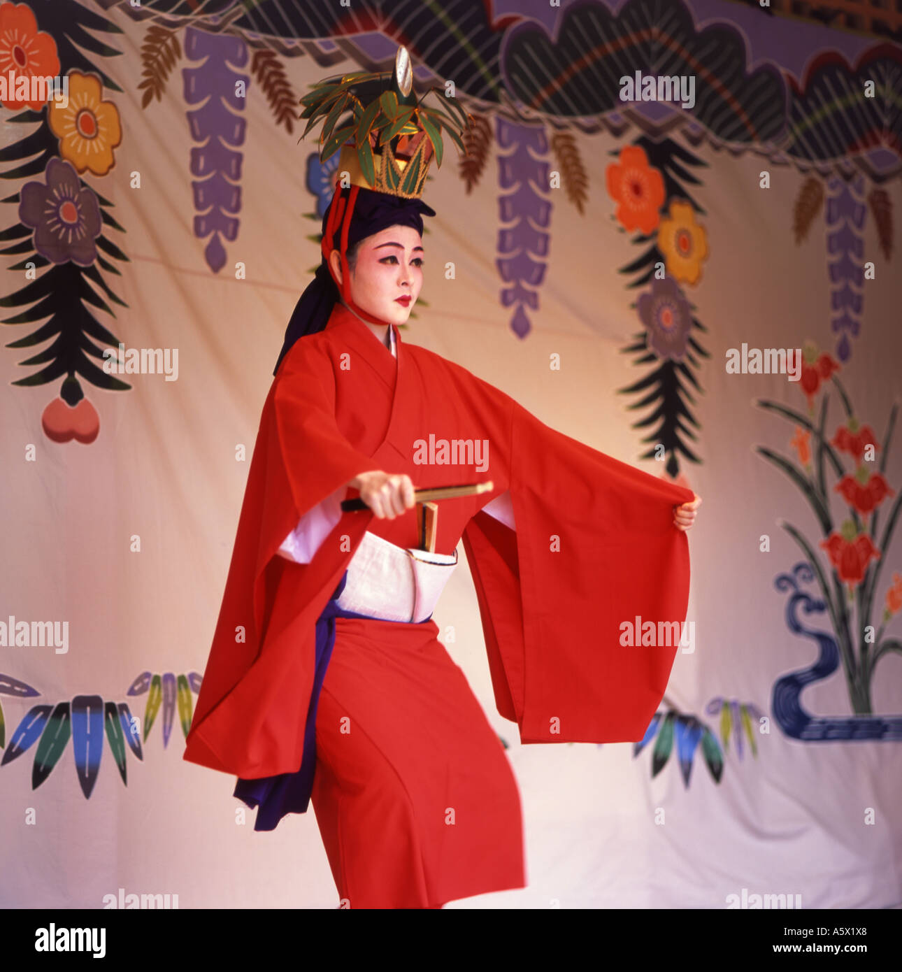Shuri Castle, Okinawa, Japan a UNESCO world heritage site. Woman performing tradtional Okinawan dance in full costume Stock Photo