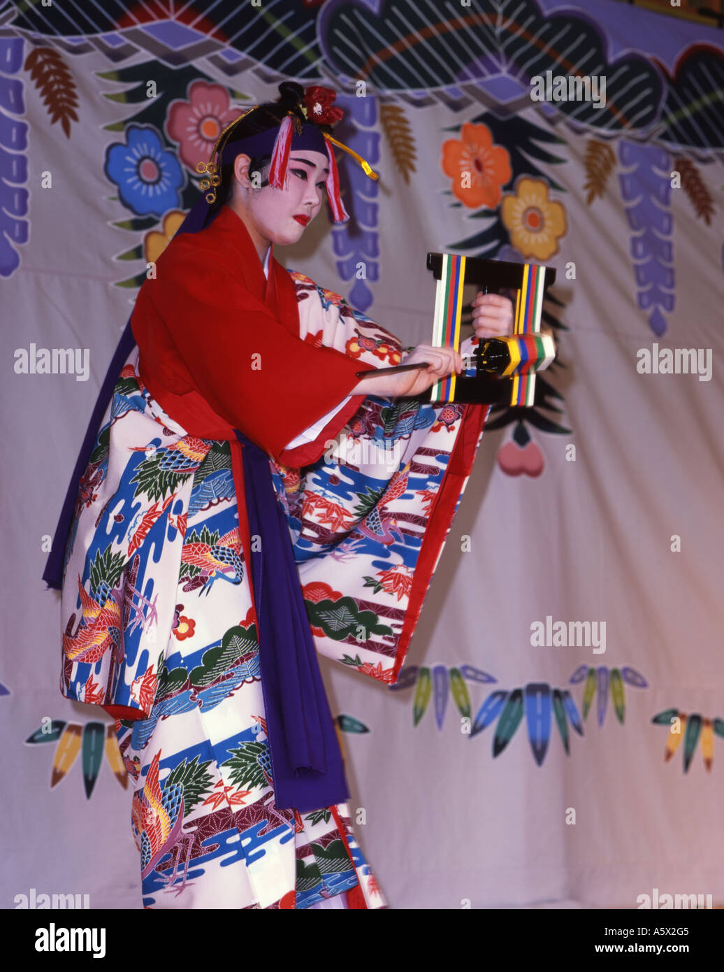 Shuri Castle, Okinawa, Japan a UNESCO world heritage site. Woman performing tradtional Okinawan dance in full costume Stock Photo