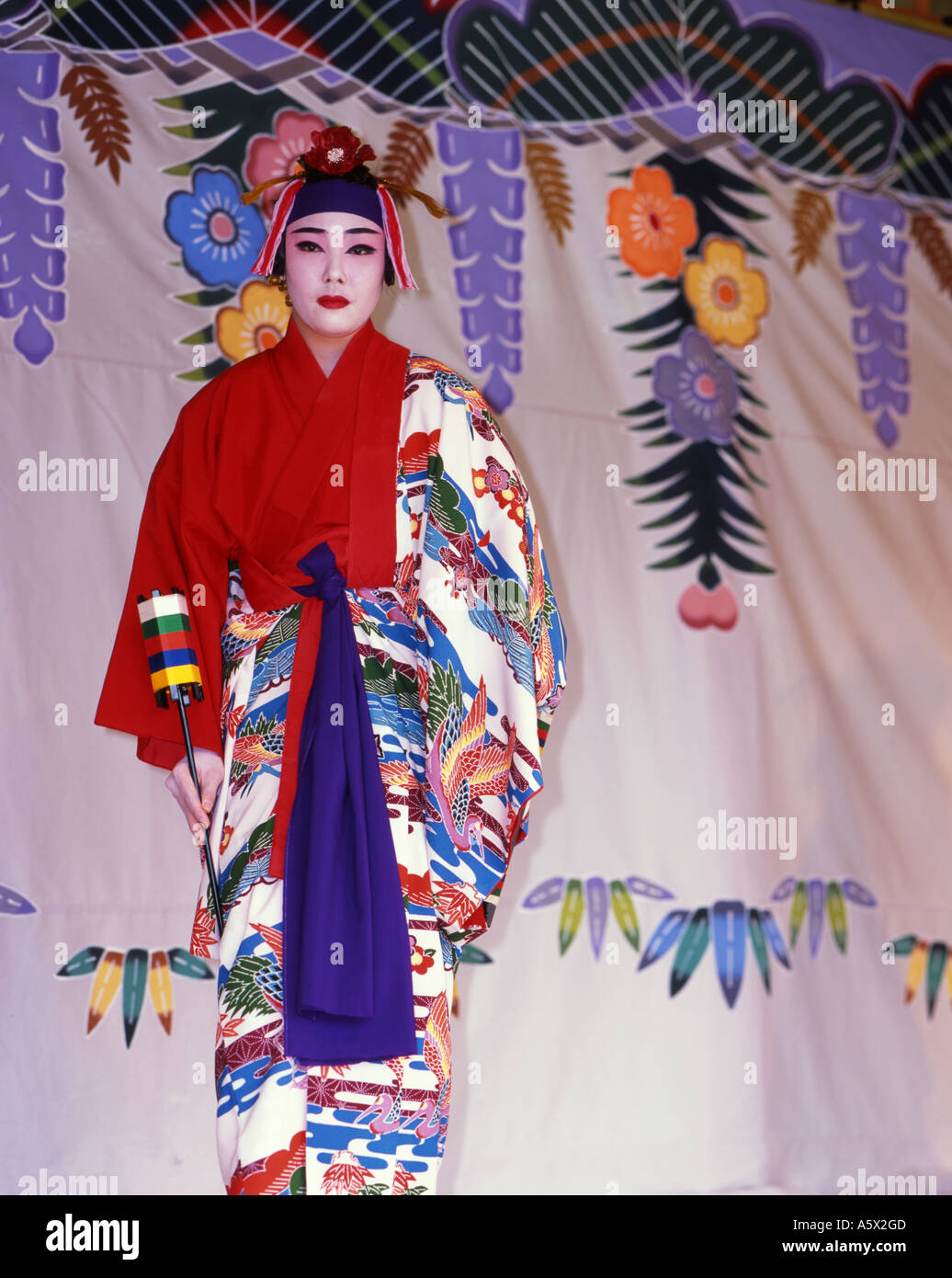 Shuri Castle, Okinawa, Japan a UNESCO world heritage site. Woman performing tradtional Okinawan dance in full costume Stock Photo