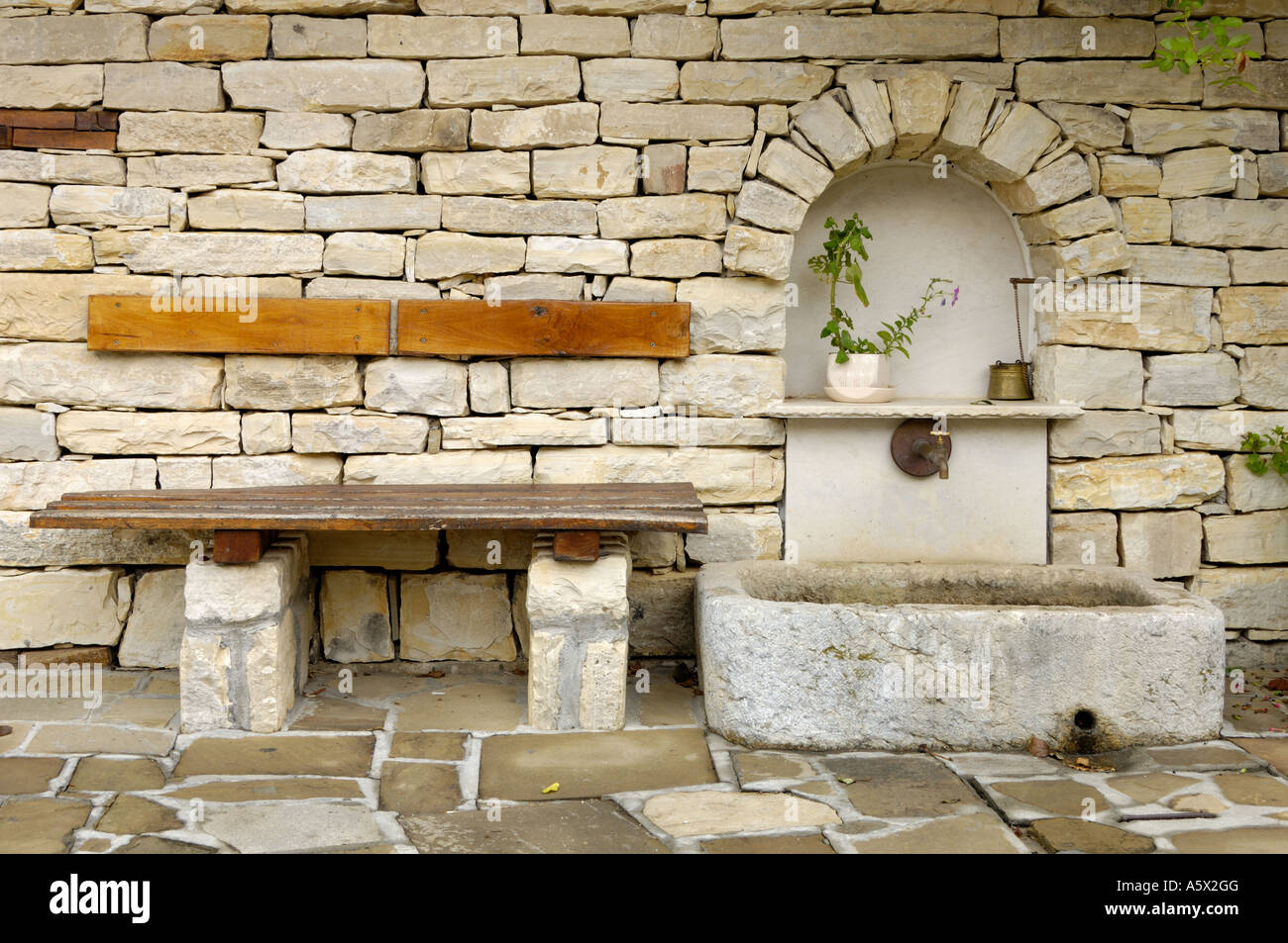 Bench besides public drinking water fountain tap Arbanassi Bulgaria East Europe Stock Photo