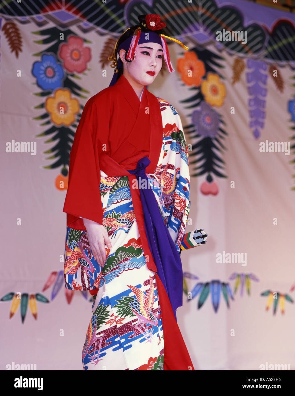 Shuri Castle, Okinawa, Japan a UNESCO world heritage site. Woman performing tradtional Okinawan dance in full costume Stock Photo