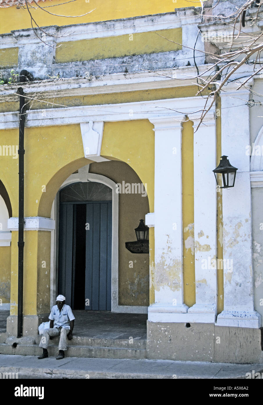 Man sitting in doorway Matanzas Cuba  Stock Photo