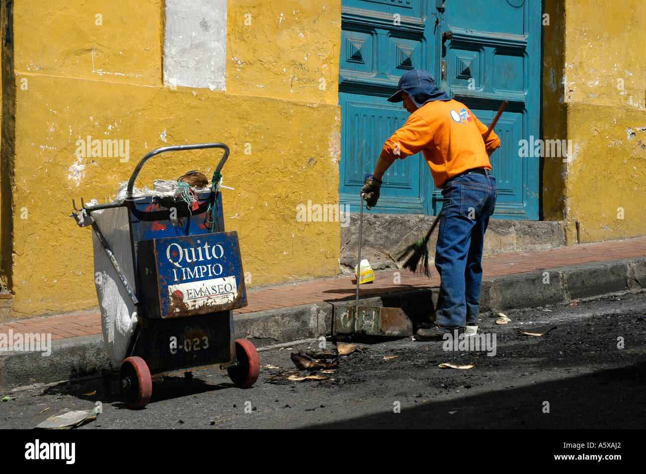 Dirt wiper cleaning downtown after new years's eve, Quito, Pichincha