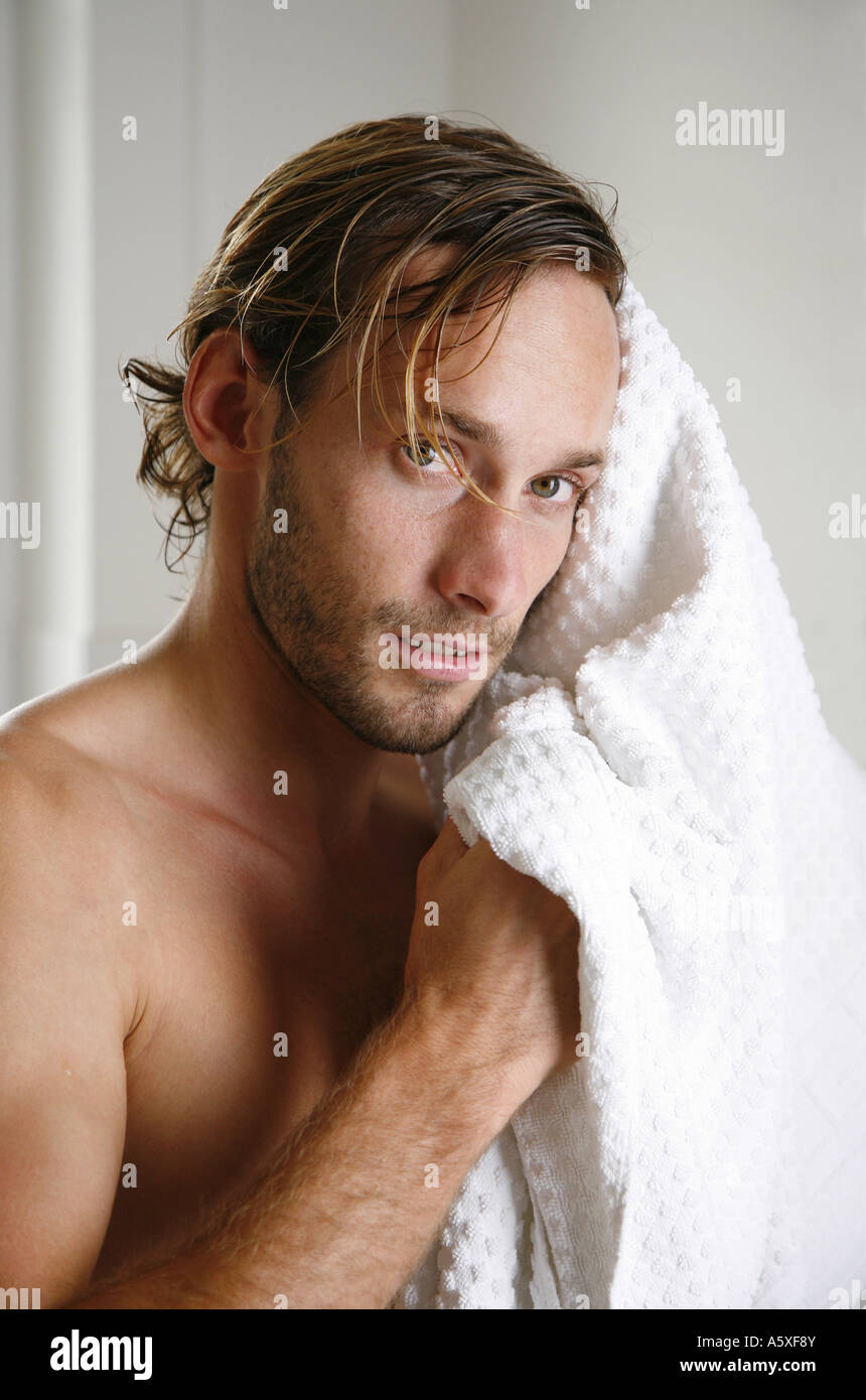 Young man drying his hair with towel close up portrait Stock Photo Alamy