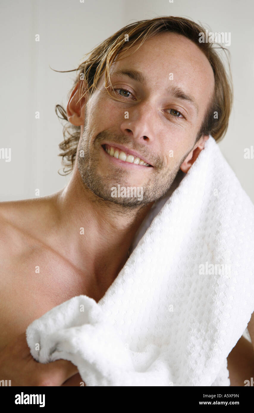 Young man drying his hair with towel close up portrait Stock Photo Alamy