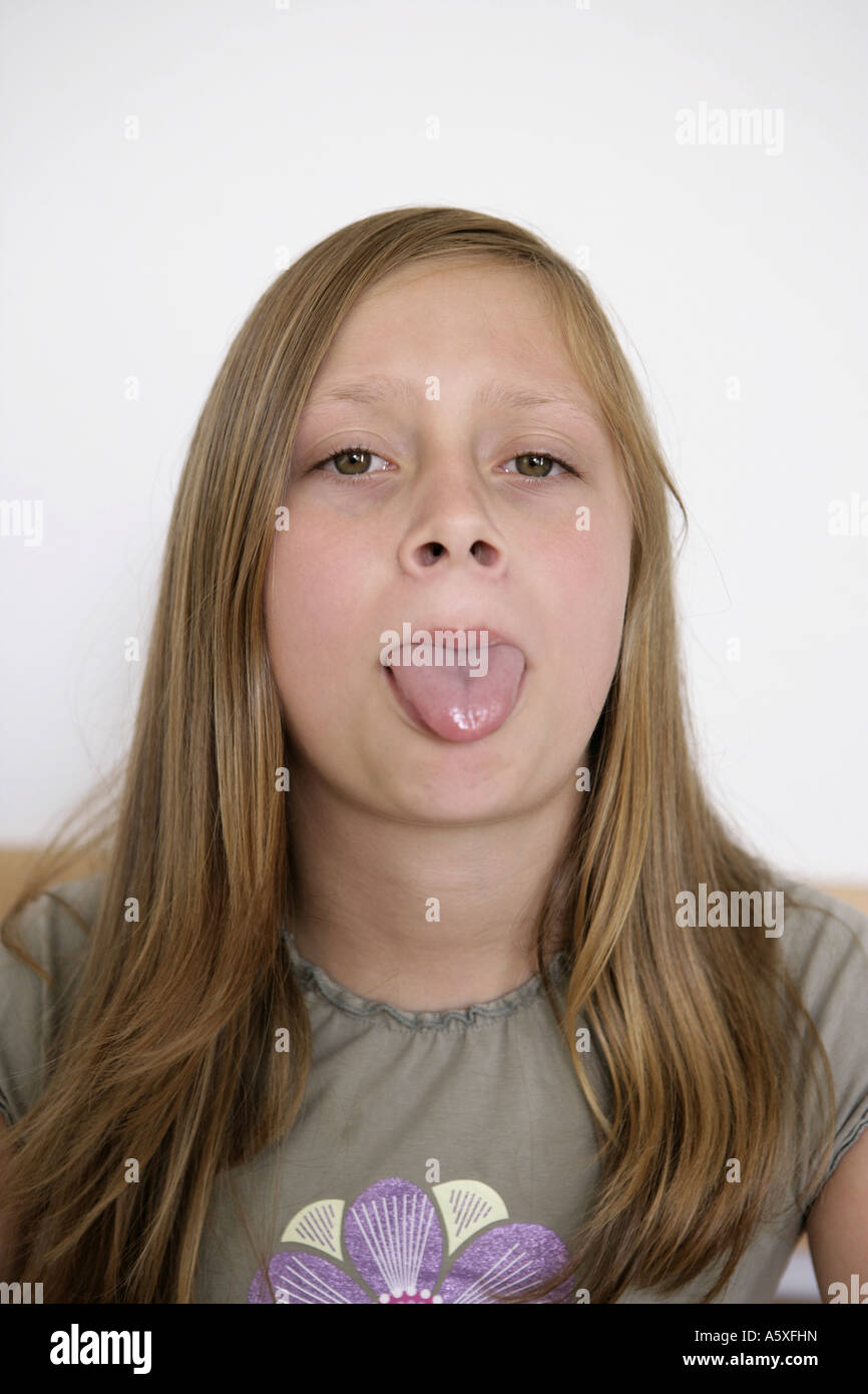 Girl sticking out tongue close up Stock Photo Alamy