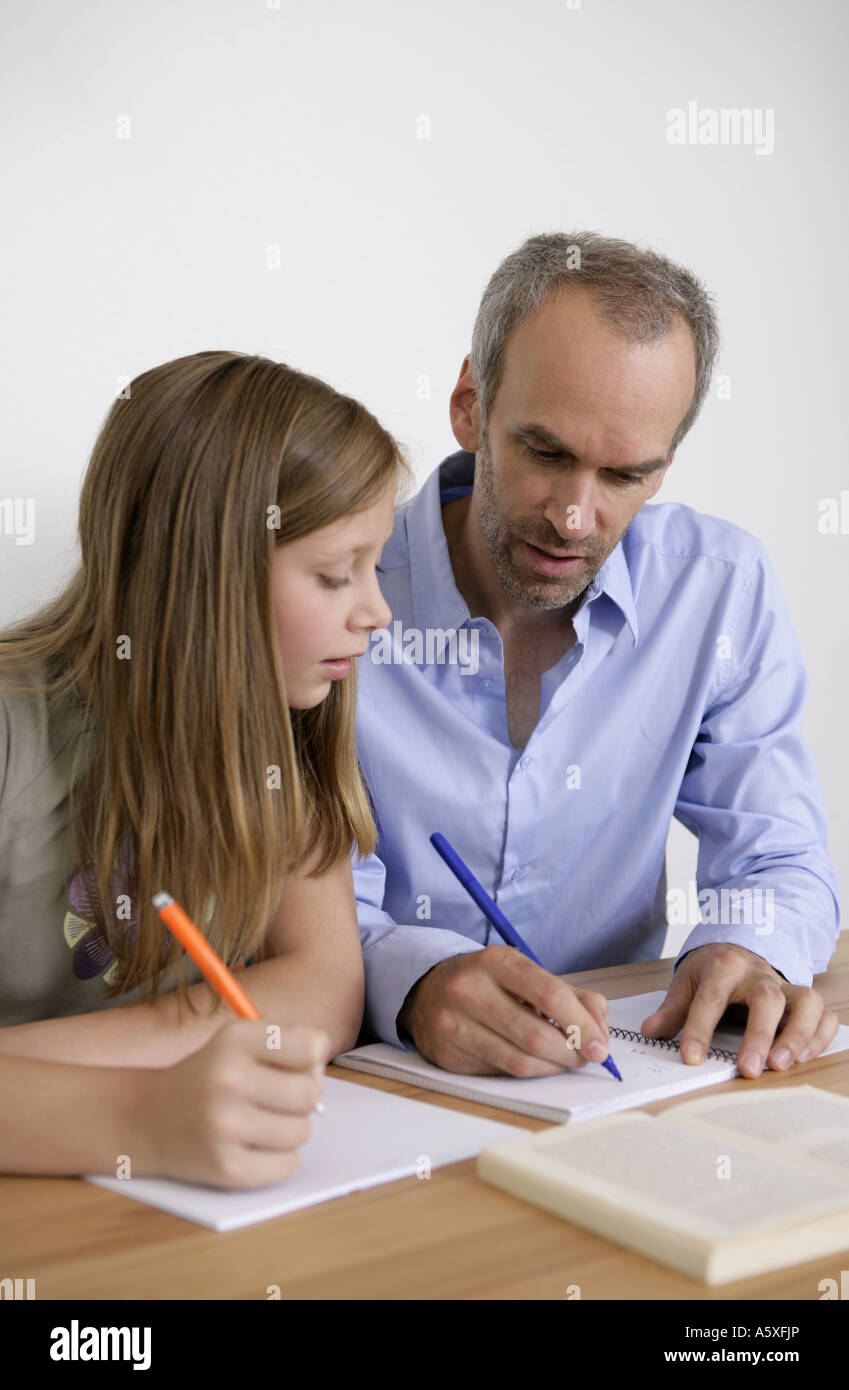 Father taking homework of daughter Stock Photo