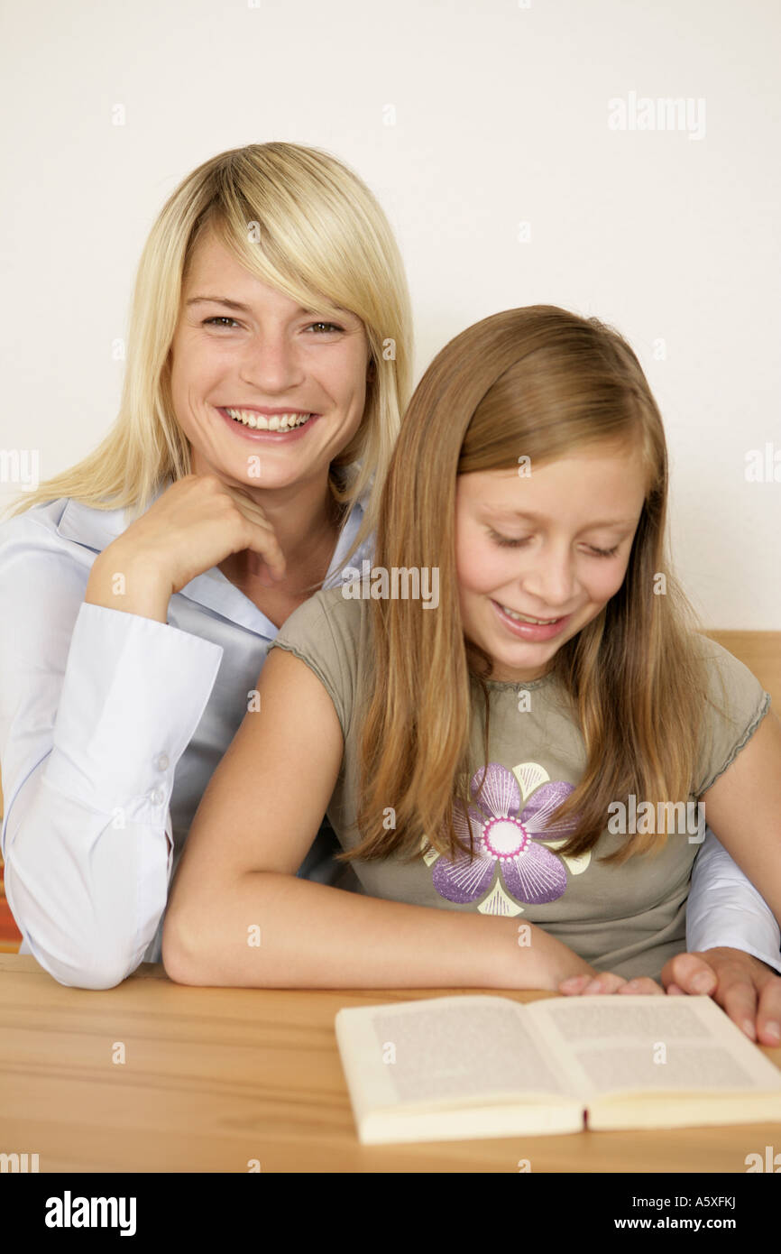 Mother taking homework of daughter smiling Stock Photo