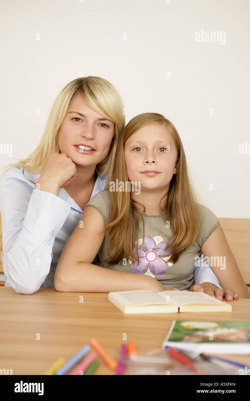 Mother taking homework of daughter Stock Photo