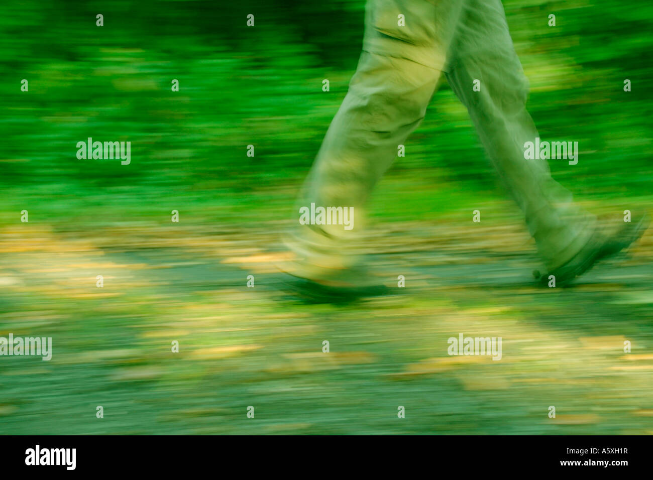 Man walking low section blurred motion Stock Photo