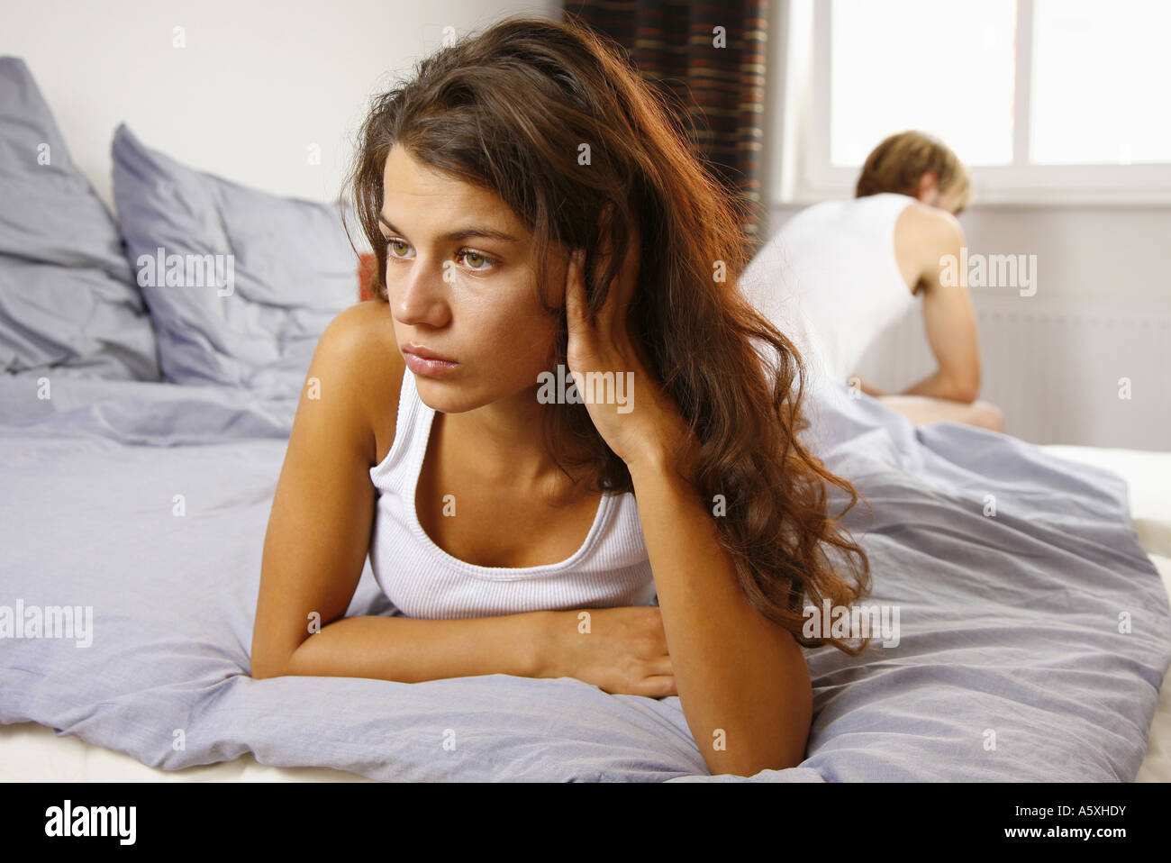 Young couple on bed focus on woman in foreground Stock Photo