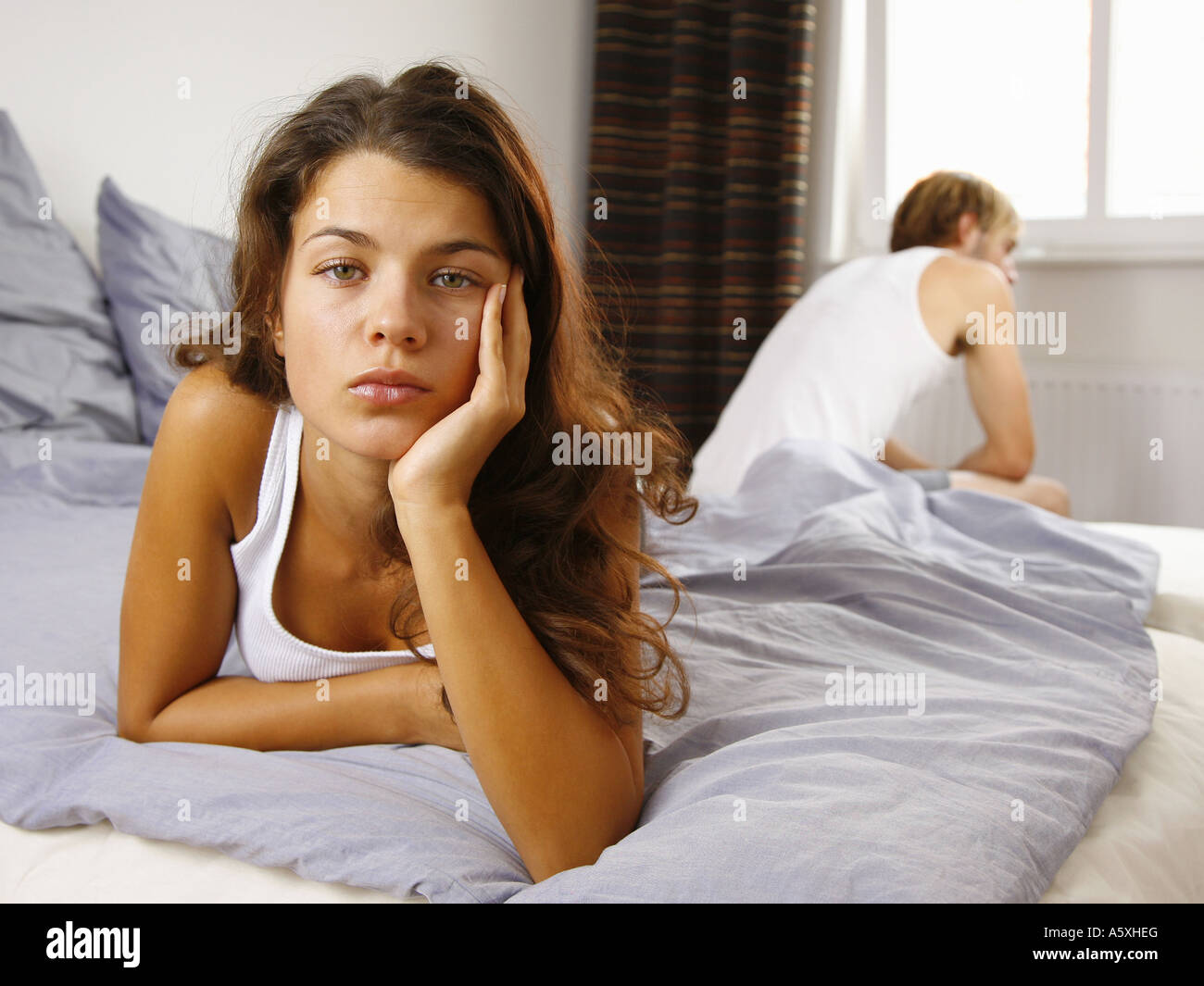 Young couple on bed focus on woman in foreground Stock Photo