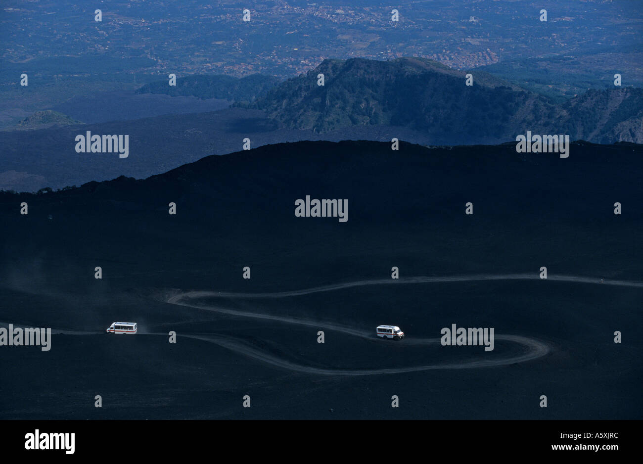 Dirty road on Mount Etna flanks. Sentier en lacets sur les flancs de l'Etna. Stock Photo
