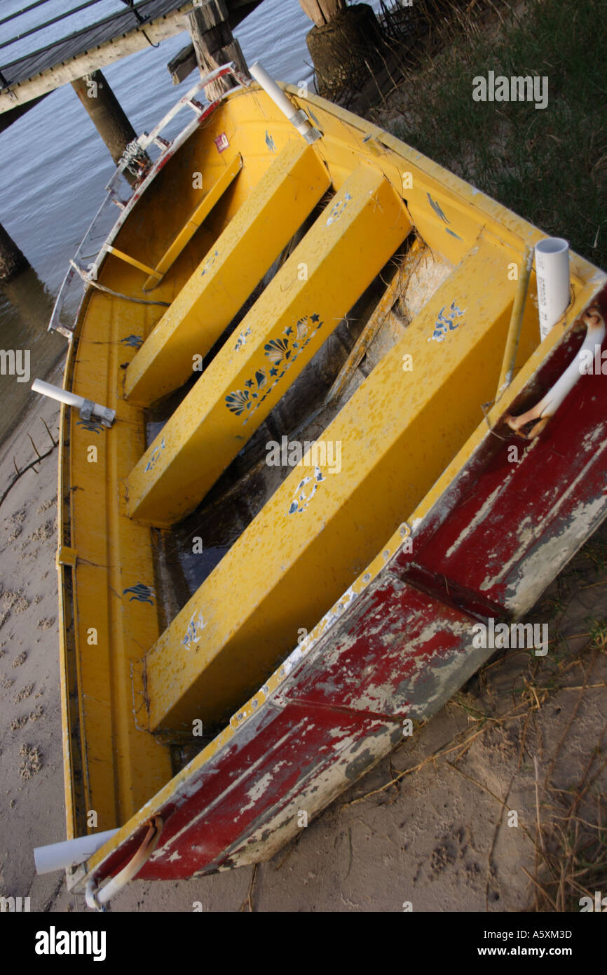 THE INSIDE OF A YELLOW DINGHY PULLED UP ON A BEACH Stock Photo