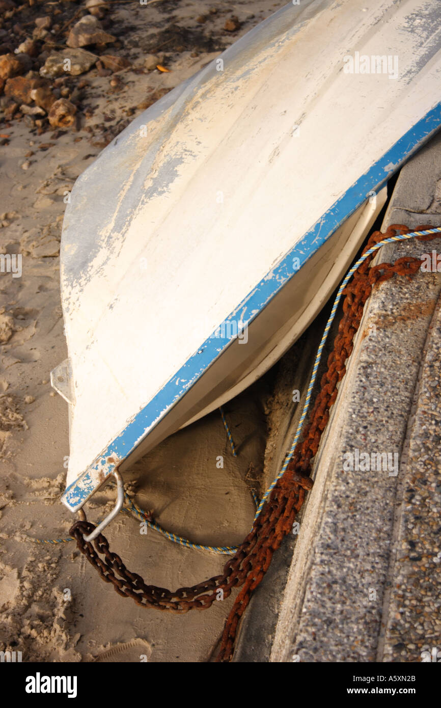DINGHY TURNED ON ITS SIDE OUT OF THE WATER Stock Photo