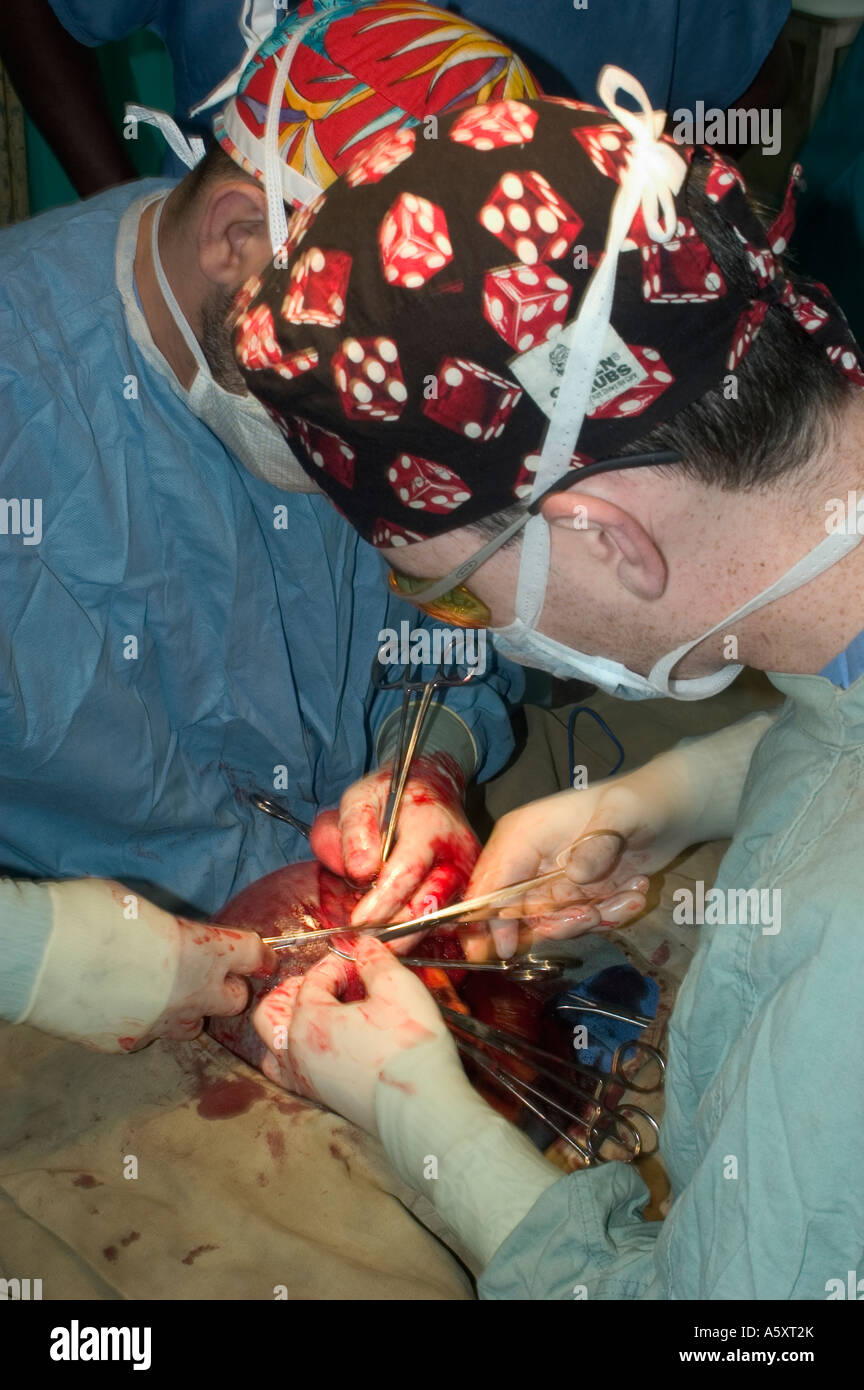 Volunteer surgeons in Nigeria wearing face mask cap gloves and gown to prevent the spread of infections during surgery Stock Photo