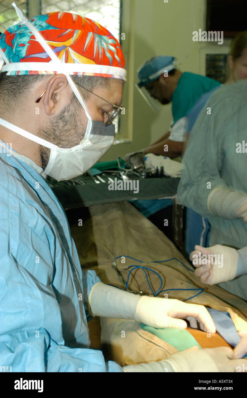 Volunteer surgeons in Nigeria wearing face mask cap gloves and gown to prevent the spread of infections during surgery Stock Photo