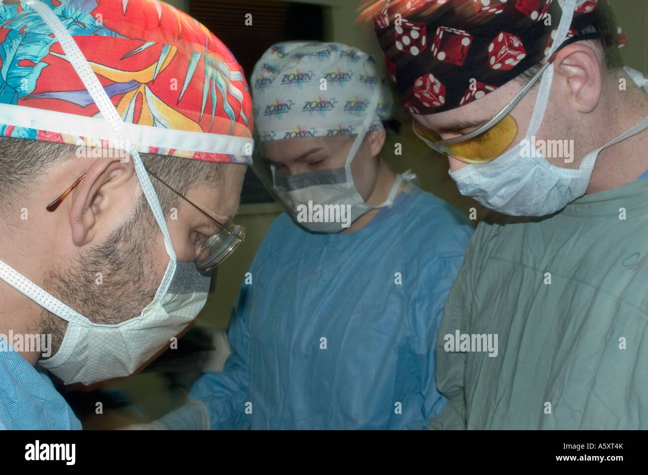 Volunteer surgeons in Nigeria wearing face mask cap gloves and gown to prevent the spread of infections during surgery Stock Photo