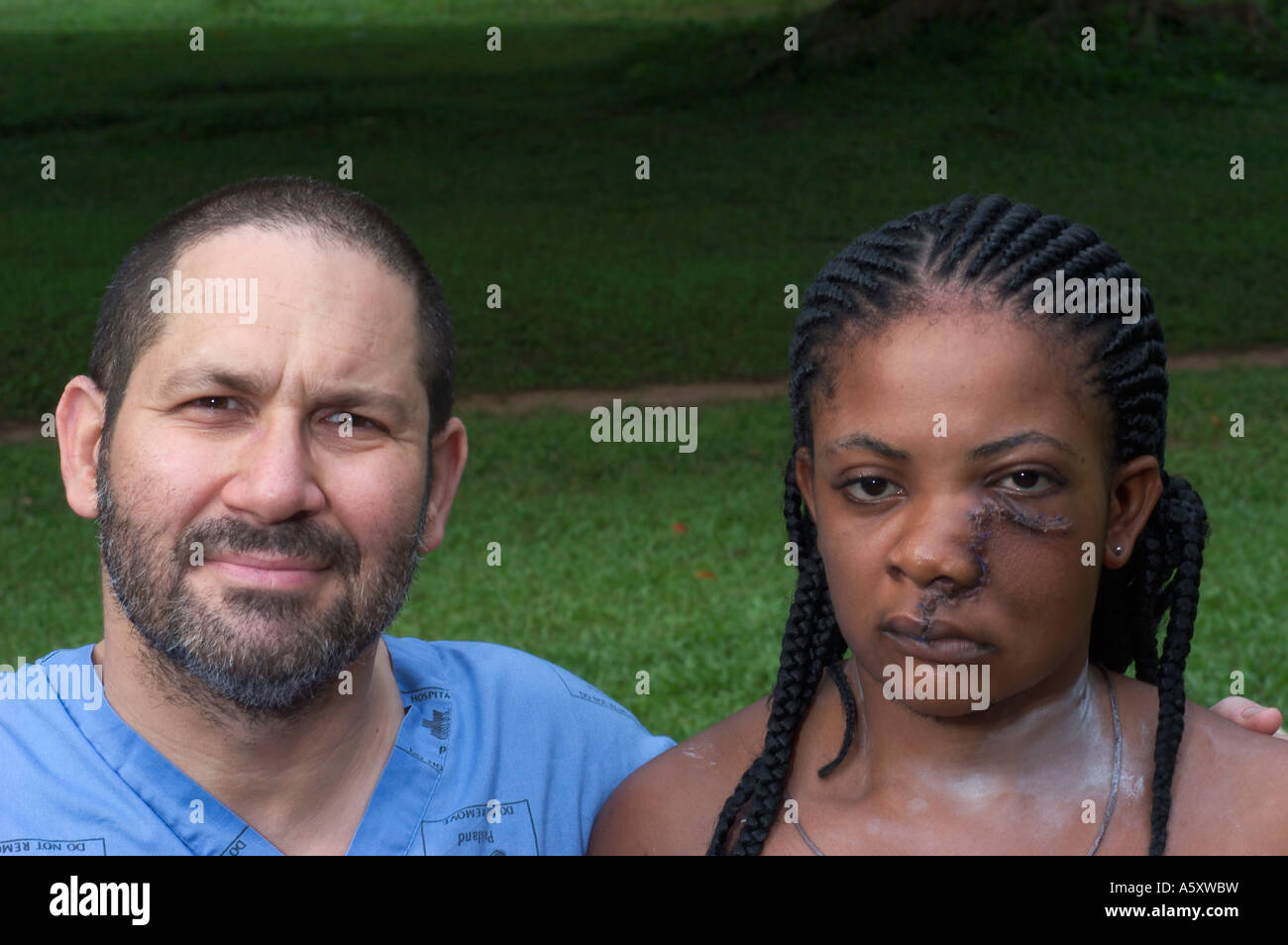 missionary surgeon posing with his patient who was operated upon for a maxillary tumor Stock Photo