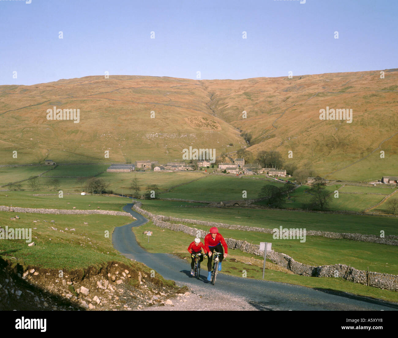 Cycling in upper Littondale, village of Halton Gill beyond, Yorkshire Dales National Park, North Yorkshire, England, UK. Stock Photo