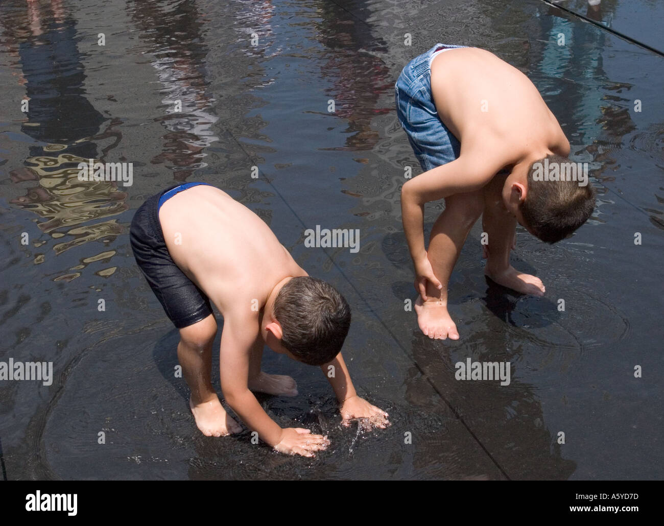 Two boys playing in water Crown Fountain Millennium Park Chicago Illinois USA Stock Photo