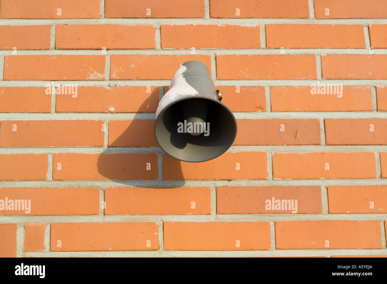 loudspeaker on red brick wall Stock Photo