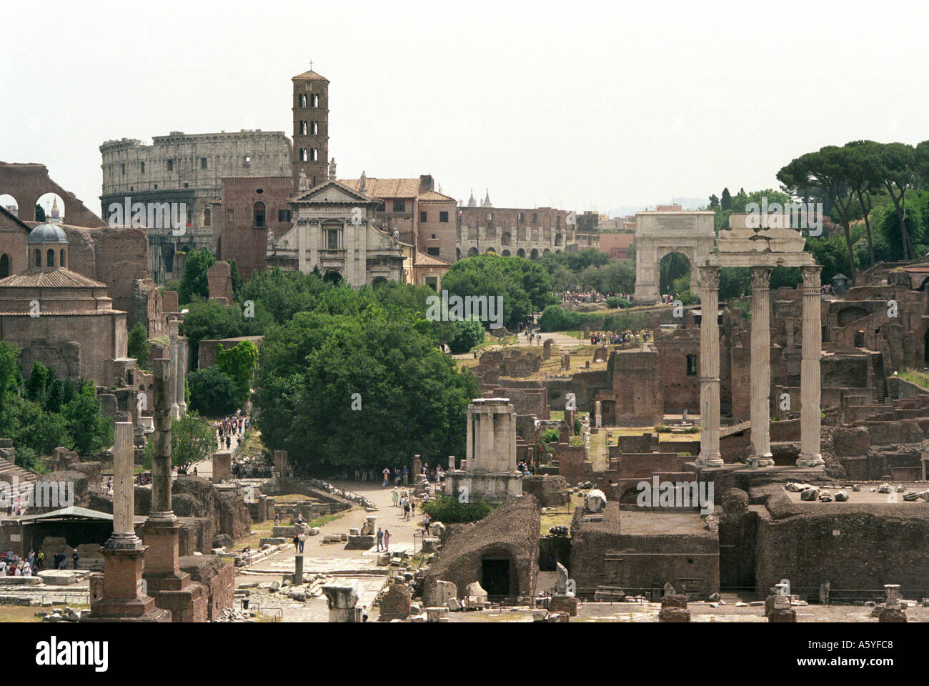 A zoom shot of the Forum in Rome with the Colosseum in the distance Stock Photo