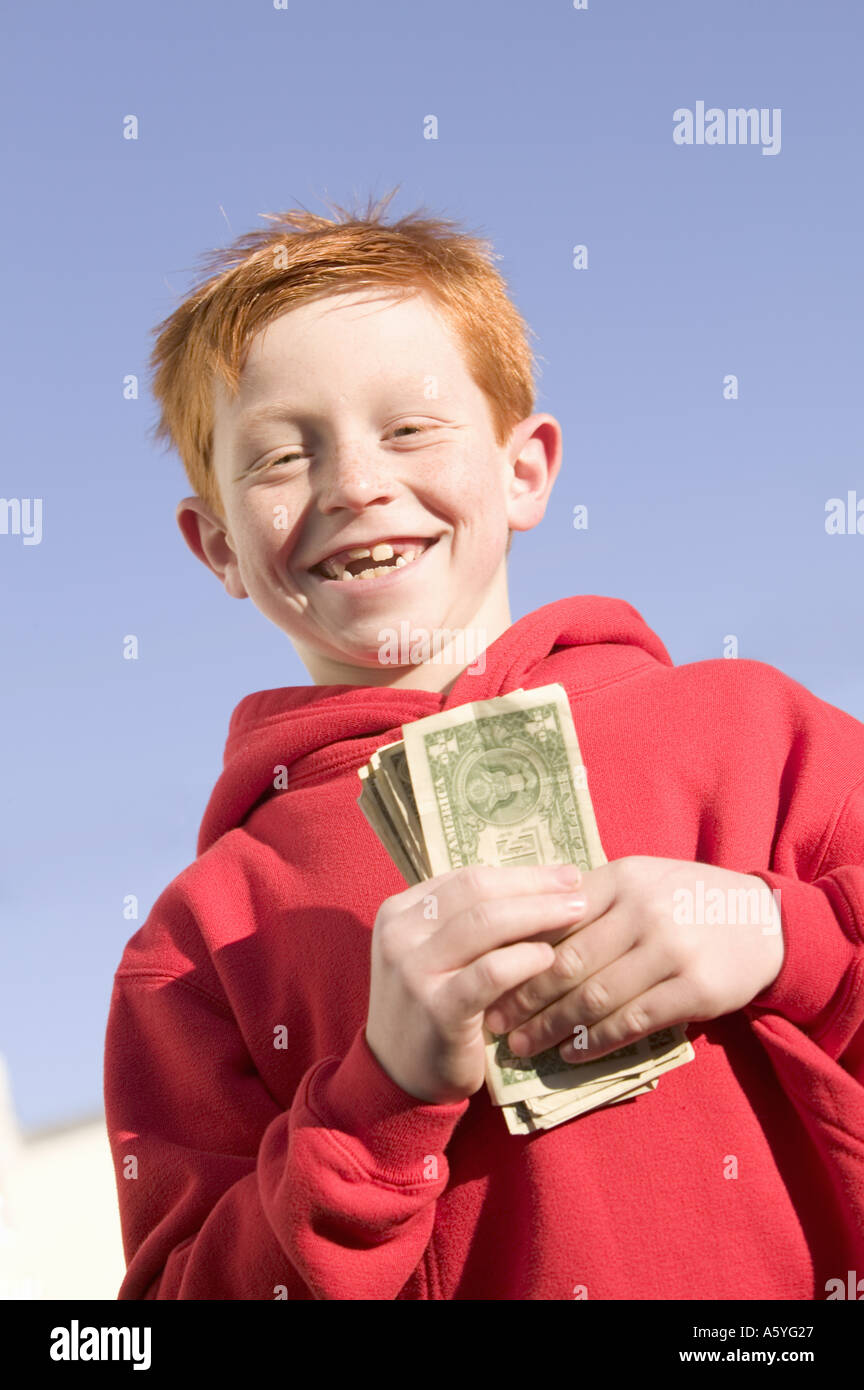 Happy boy holding American currency Stock Photo