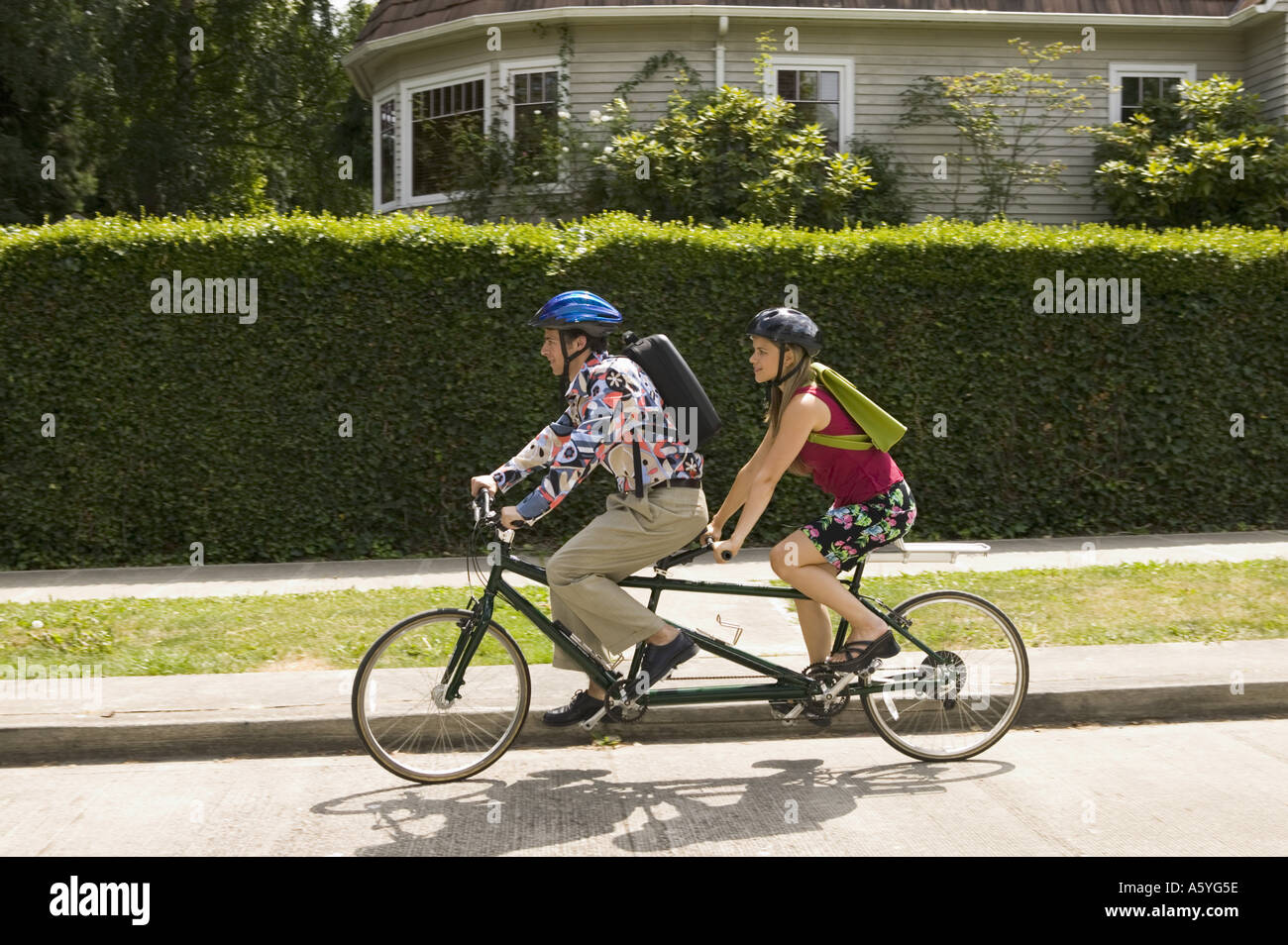 Couple riding tandem bicycle Stock Photo