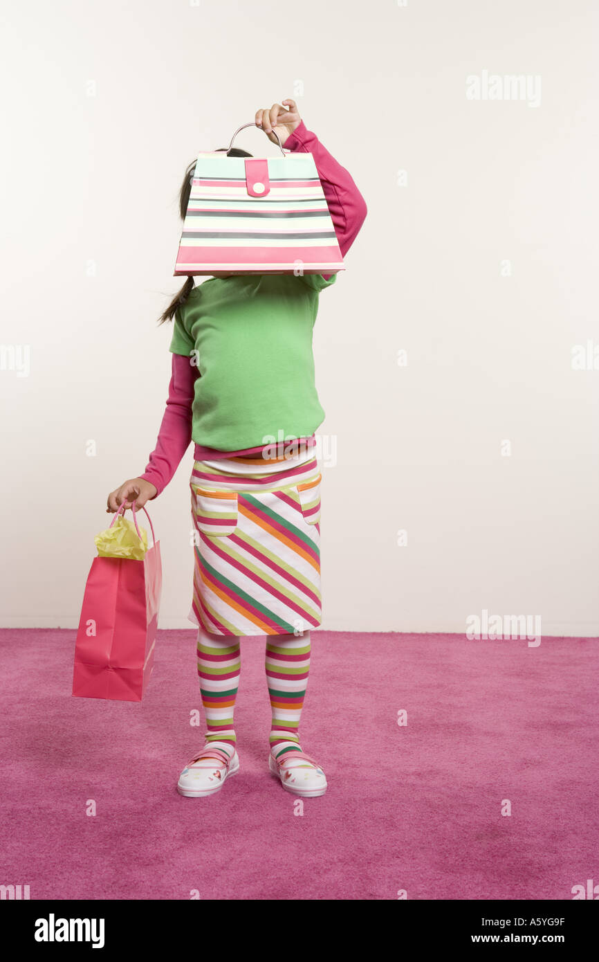 Girl holding purse in front of face Stock Photo Alamy