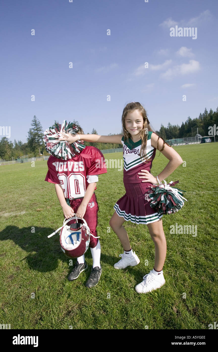 Cheerleader posing with football player Stock Photo