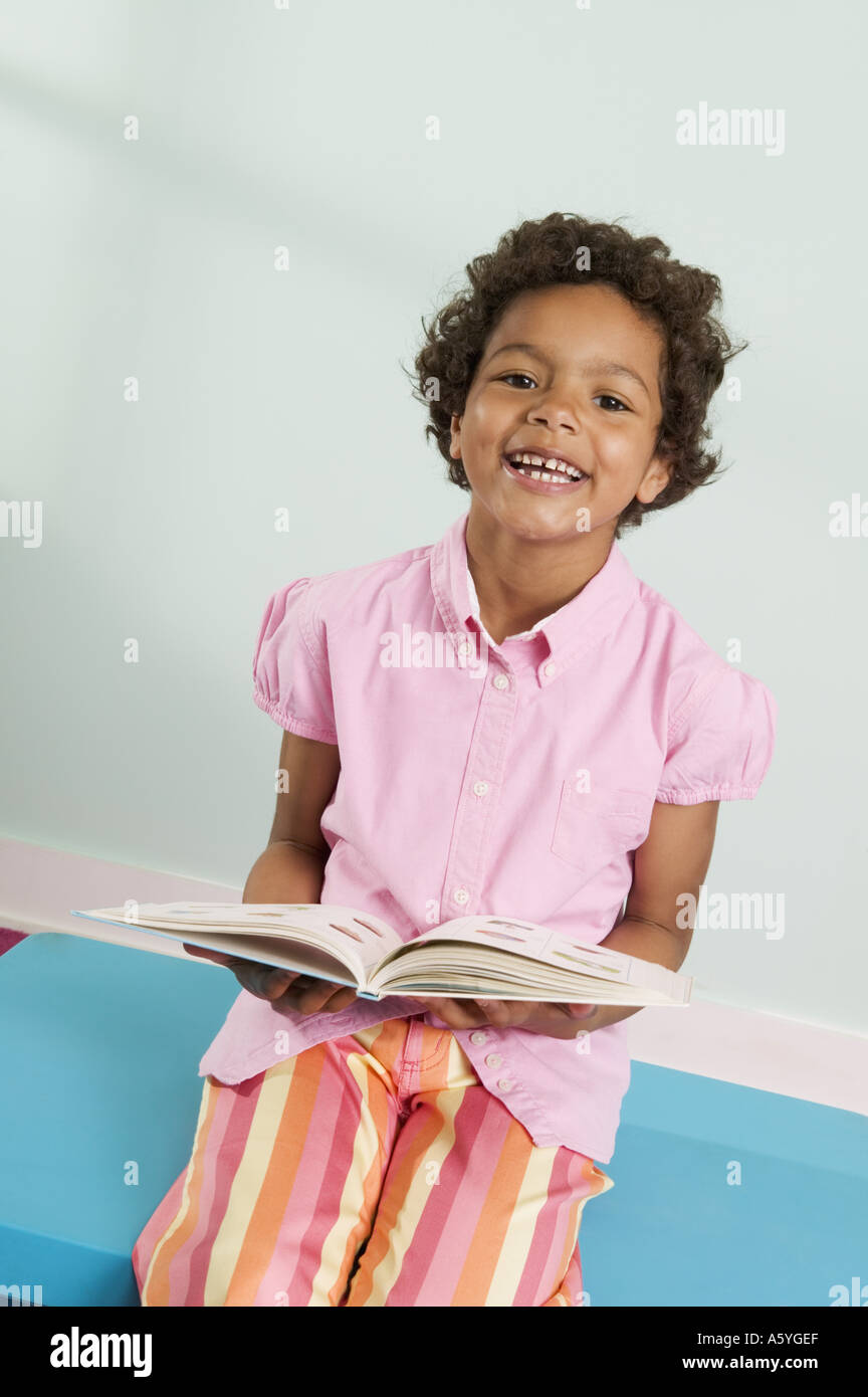 Smiling girl holding book Stock Photo