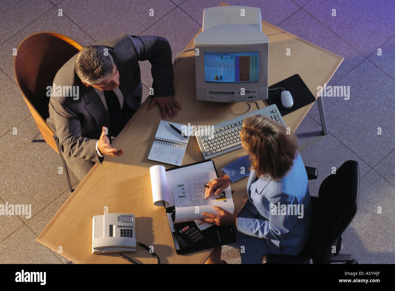 High angle view of two businesspeople discussing in office Stock Photo
