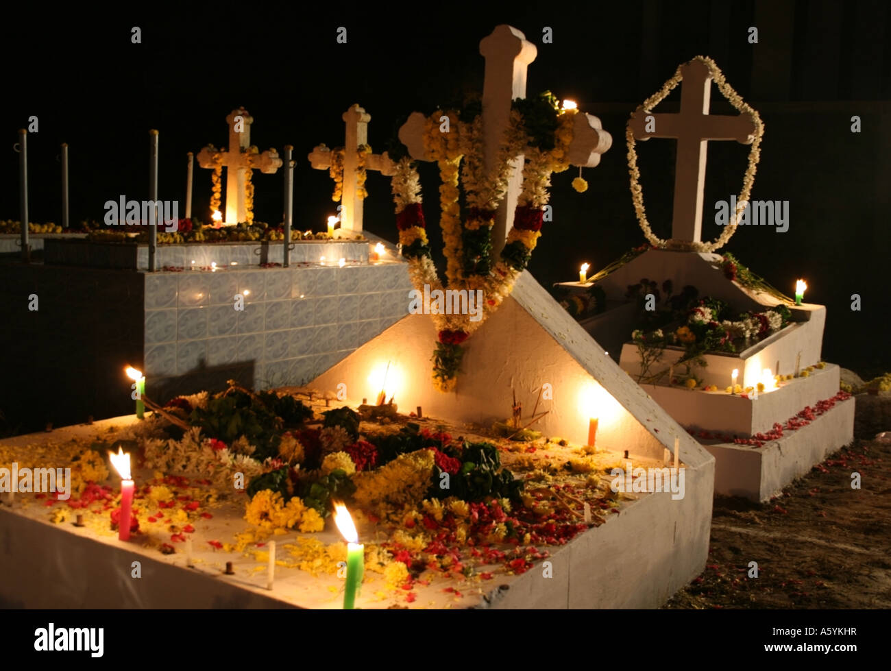All Saints Grave decorated with candles , flowers petals for All saints