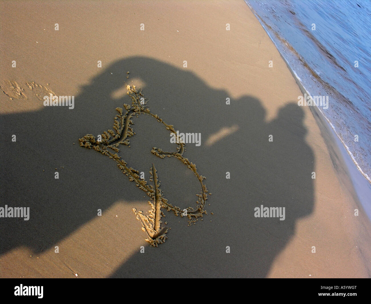 shadow of a loving couple on heart with an arrow as a love message ...