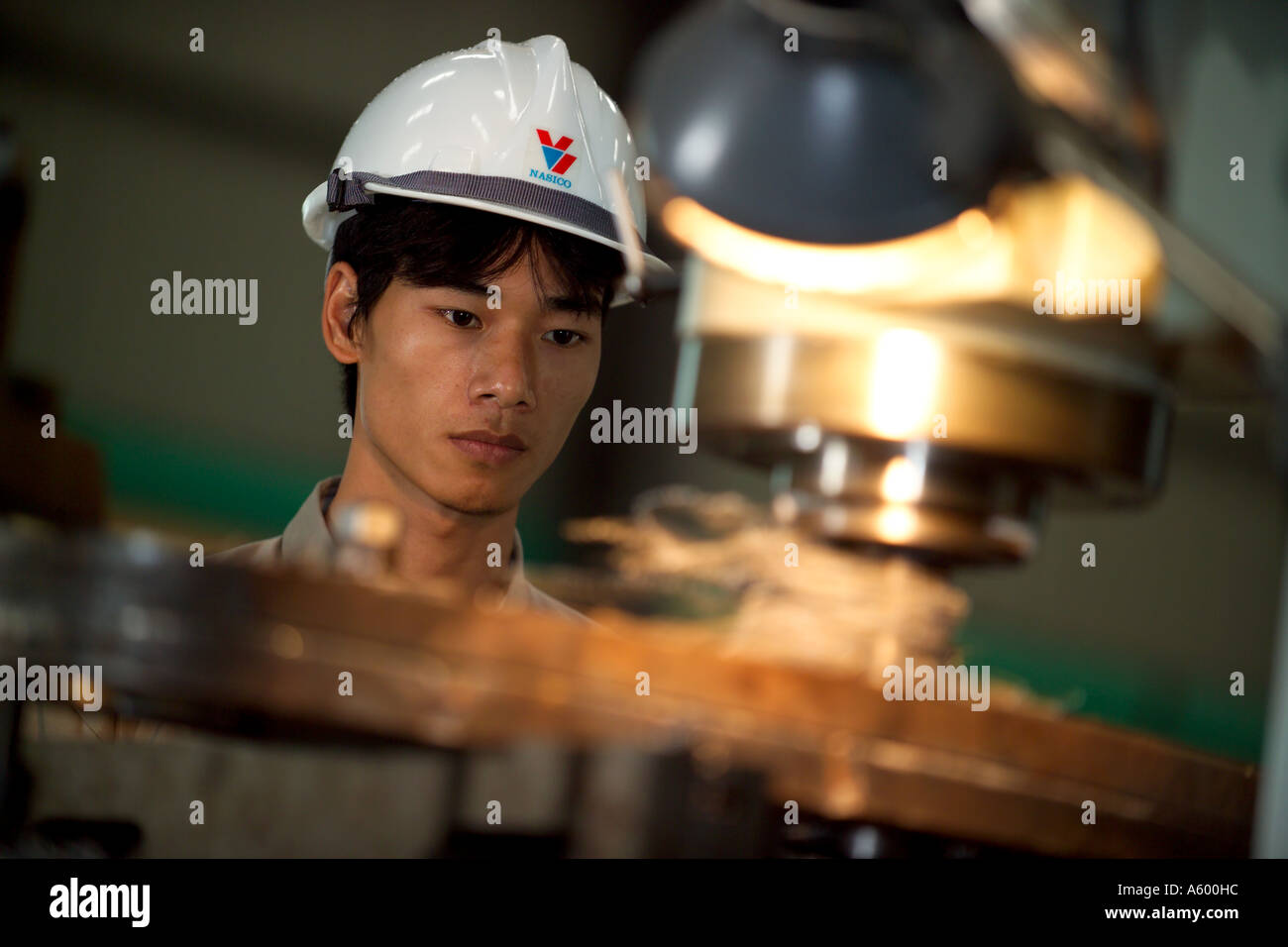 Apprentice Vietnamese shipyard worker, in engineering workshop, Vietnam, Asia Stock Photo