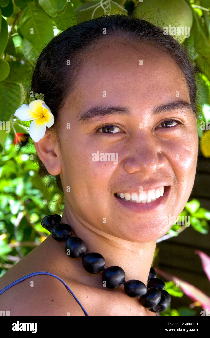 Tahitian woman wearing a plumeria flower in her hair on the island of