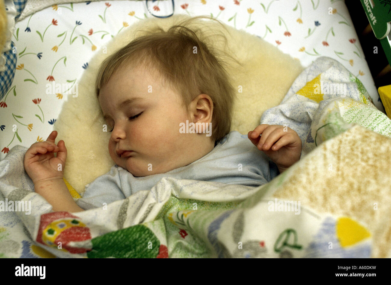 six month old baby girl asleep in her crib Stock Photo Alamy