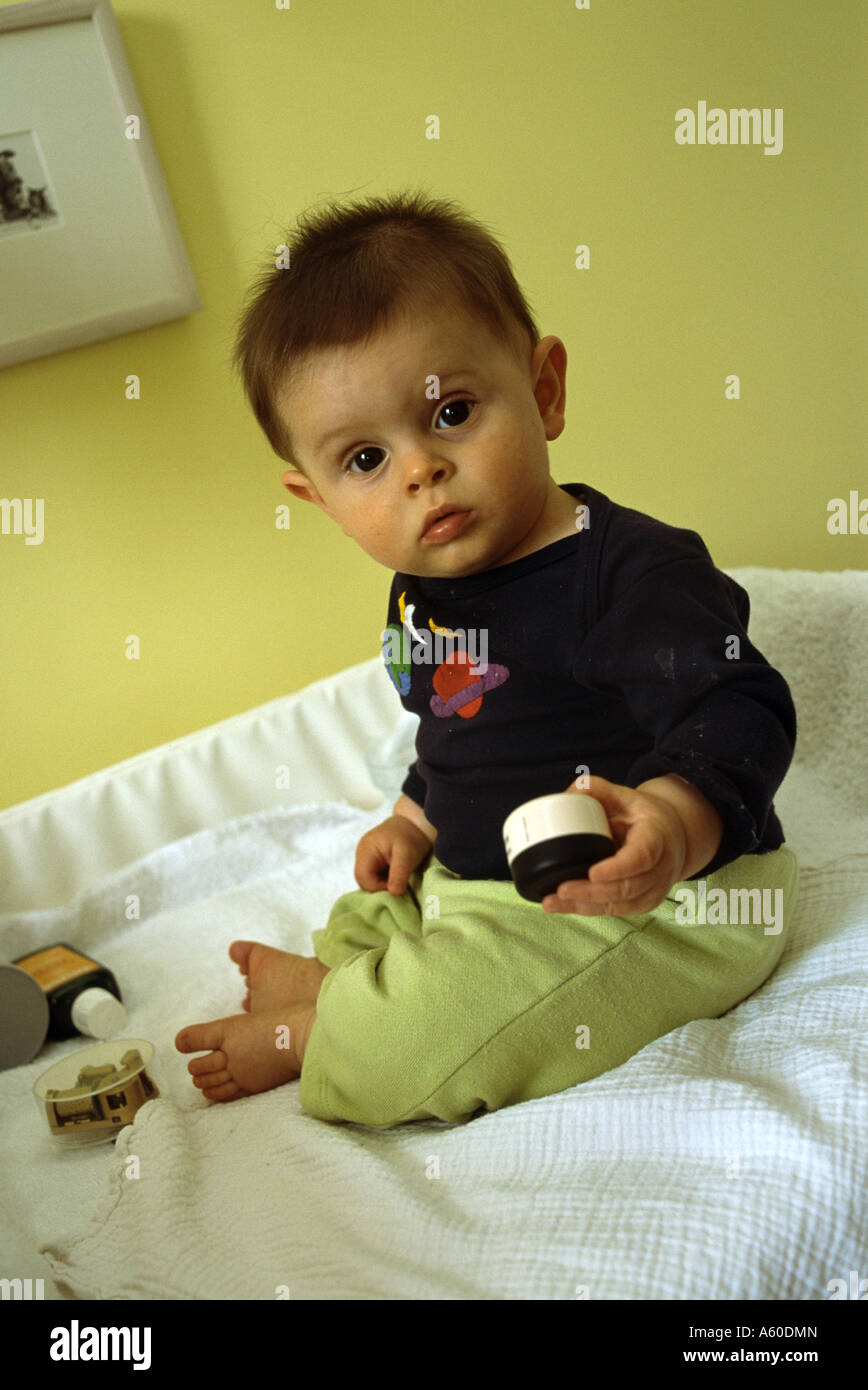 Seven month baby boy sitting up on his own with no support Stock Photo