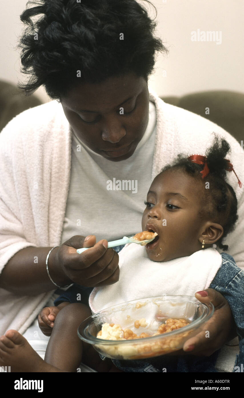 https://c8.alamy.com/comp/A60DTR/black-mother-spoon-feeding-baby-daughter-A60DTR.jpg