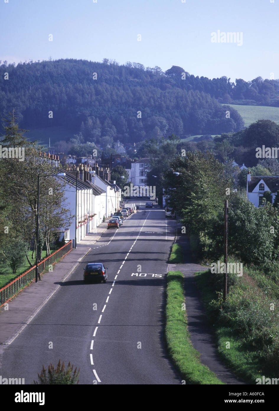 dh  GATEHOUSE OF FLEET DUMFRIES Road into town line of white houses car travelling country lane motoring travel driving scotland holiday Stock Photo