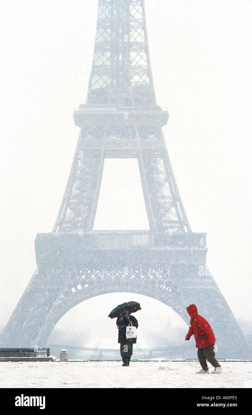 Tourists promenading in Winter, PARIS France, "Eiffel Tower" View from Trocadero Plaza Two People in Snow Storm Child Cold Weather Stock Photo