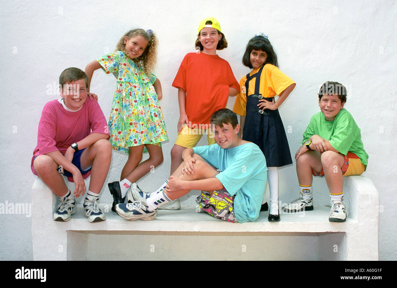 Group of young junior boys and girls 6 to 10 years pose for the camera in a selection of colourful clothing styles Stock Photo