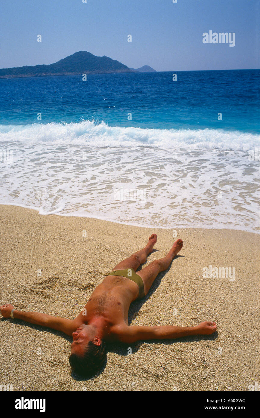 sunbather on Kaputas beach south coast near Kas Turkey Stock Photo